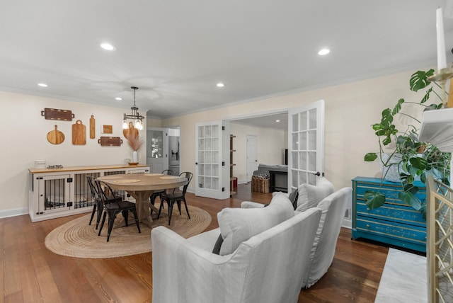 living room with ornamental molding, dark wood-type flooring, and french doors