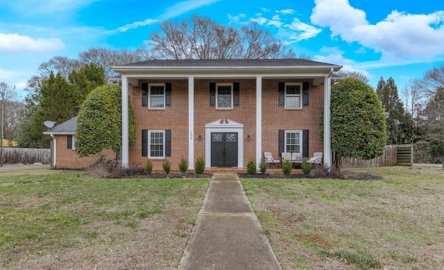 neoclassical / greek revival house featuring a front yard