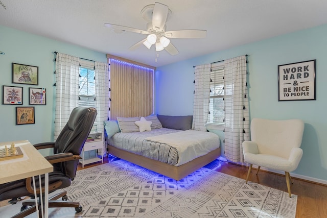 bedroom with wood-type flooring and ceiling fan