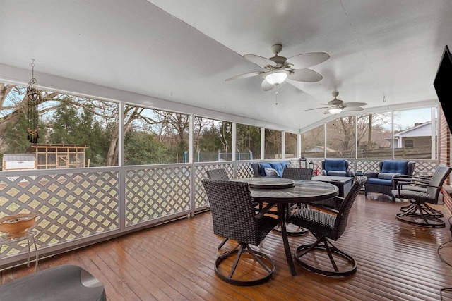 sunroom featuring ceiling fan and vaulted ceiling