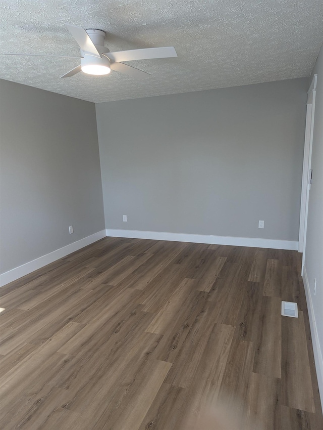 unfurnished room featuring a textured ceiling, hardwood / wood-style flooring, and ceiling fan