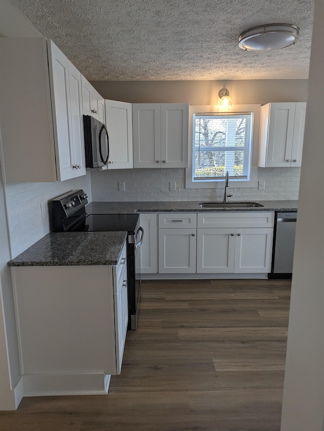 kitchen with white cabinetry, black electric range oven, sink, stainless steel dishwasher, and dark wood-type flooring