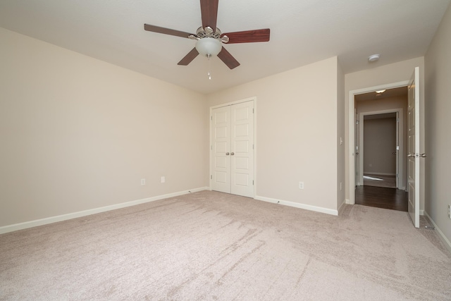 unfurnished bedroom with ceiling fan, a closet, and carpet