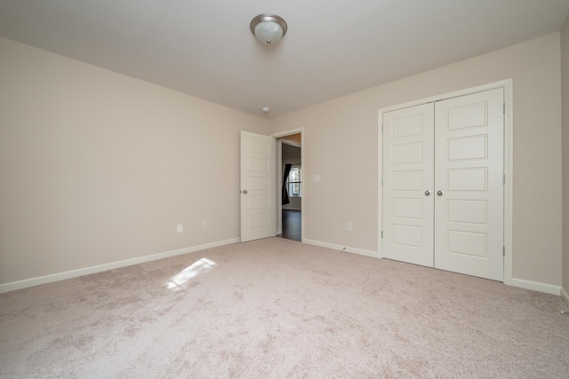 unfurnished bedroom featuring carpet floors and a closet