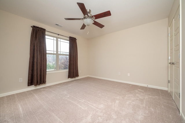 empty room with ceiling fan and carpet flooring