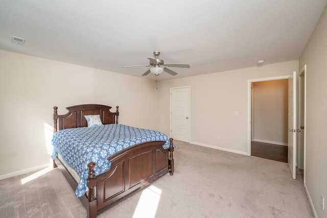 bedroom featuring light colored carpet and ceiling fan