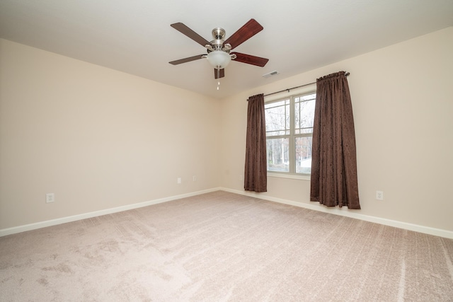 carpeted spare room with ceiling fan