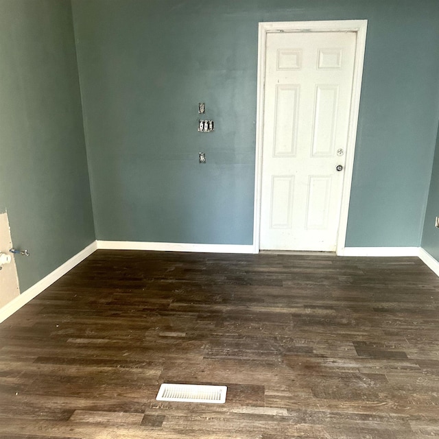 unfurnished room featuring dark wood-type flooring