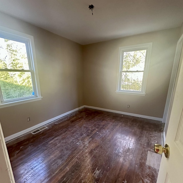 spare room with dark wood-type flooring