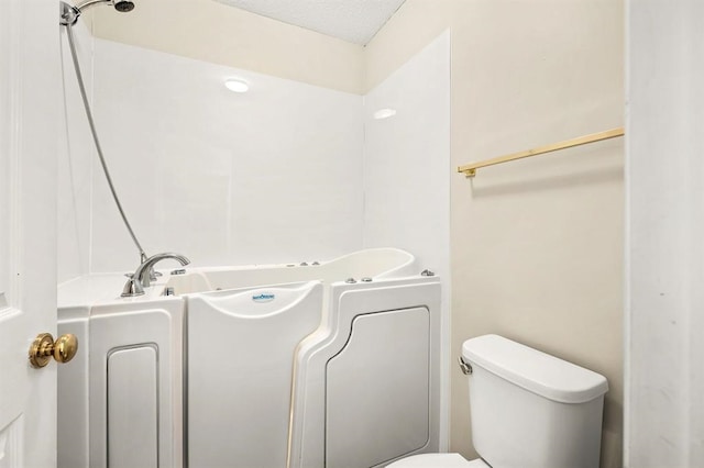 bathroom featuring a bathing tub and toilet