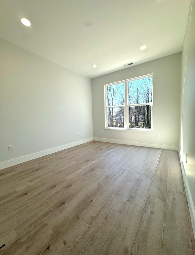 empty room with light hardwood / wood-style floors