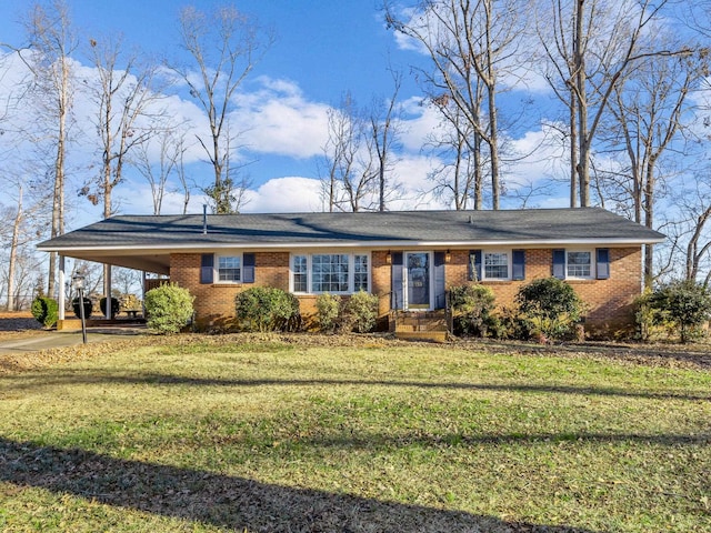 ranch-style home featuring a front lawn and a carport