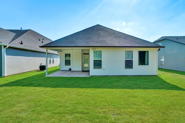 rear view of property with central AC unit, a patio, and a lawn