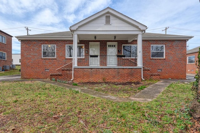 bungalow-style house with a porch, central AC, and a front lawn