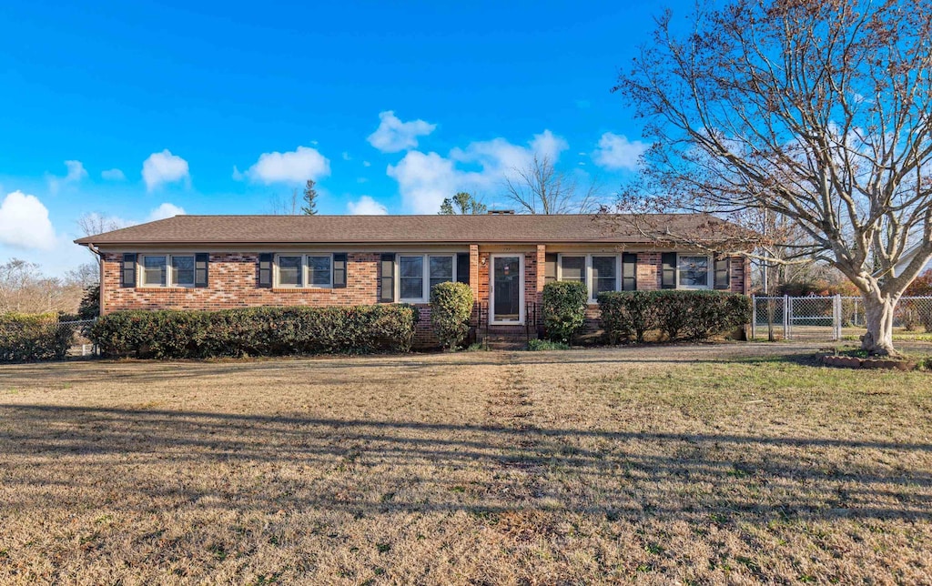 ranch-style home with a front yard