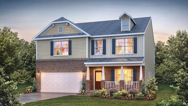 craftsman-style home with a garage, a yard, and covered porch
