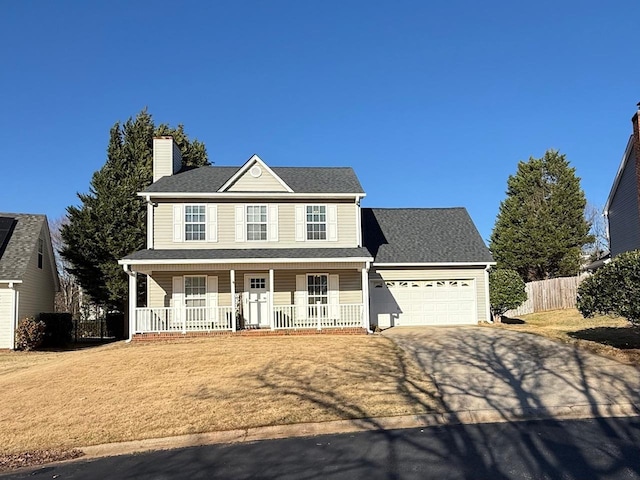 view of front facade with a garage, covered porch, and a front lawn