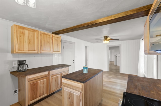 kitchen featuring beamed ceiling, ceiling fan, light brown cabinetry, and light hardwood / wood-style floors