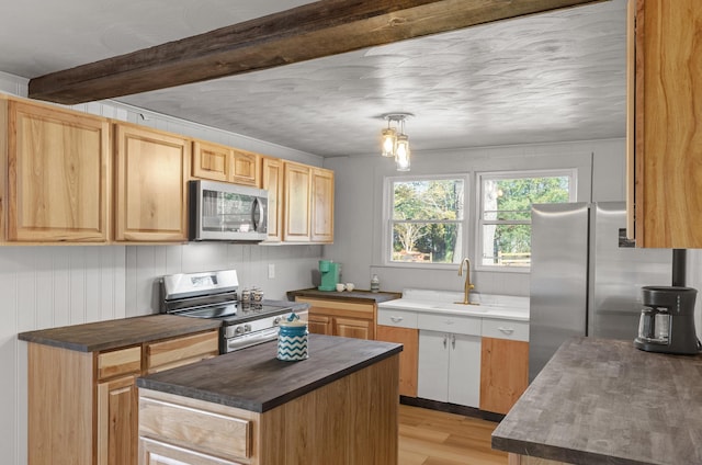 kitchen with sink, a center island, light hardwood / wood-style floors, stainless steel appliances, and beam ceiling