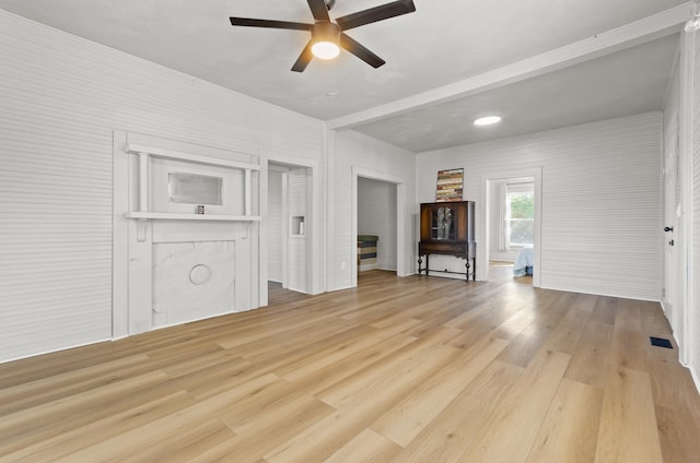 unfurnished living room with ceiling fan and light hardwood / wood-style flooring