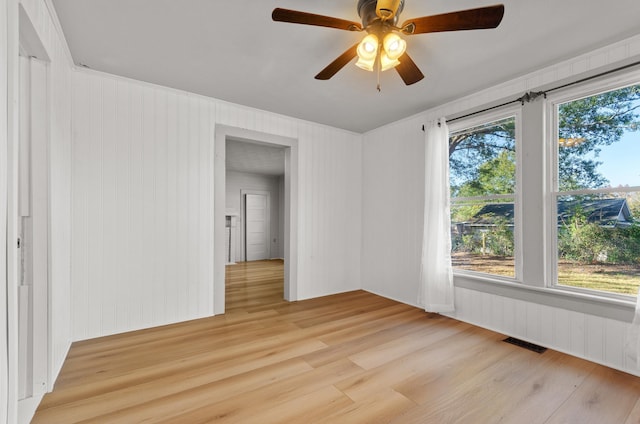 spare room featuring ceiling fan and light hardwood / wood-style flooring