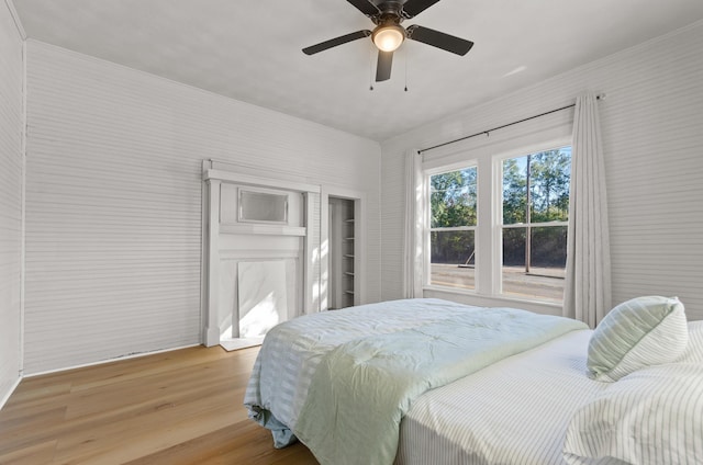 bedroom with ceiling fan and light hardwood / wood-style floors