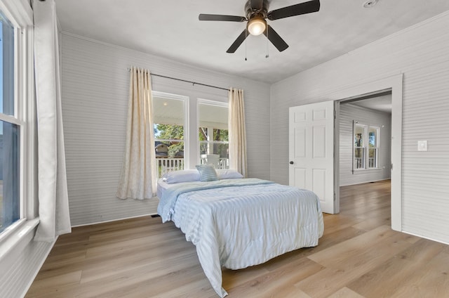 bedroom with ceiling fan and light wood-type flooring