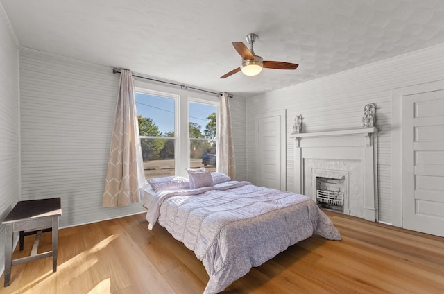 bedroom with hardwood / wood-style flooring and ceiling fan