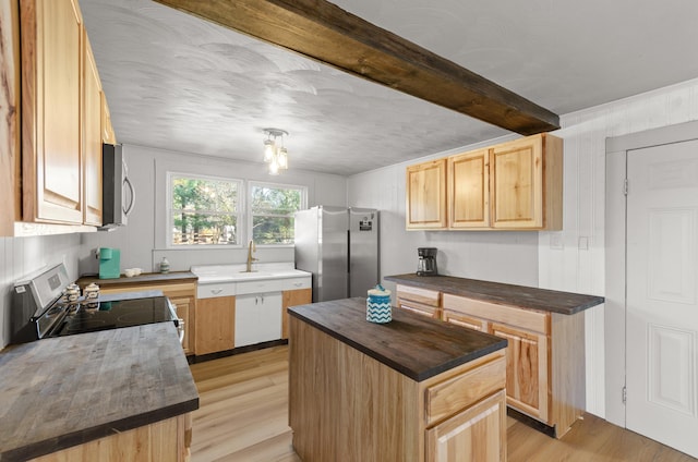 kitchen with stainless steel appliances, light hardwood / wood-style floors, a kitchen island, beamed ceiling, and light brown cabinets