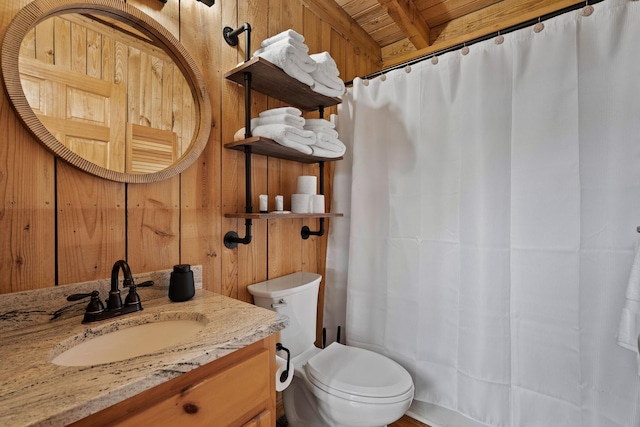 bathroom with wood ceiling, vanity, and wood walls