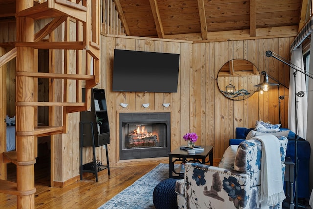 living room featuring hardwood / wood-style flooring, vaulted ceiling with beams, wood ceiling, and wooden walls