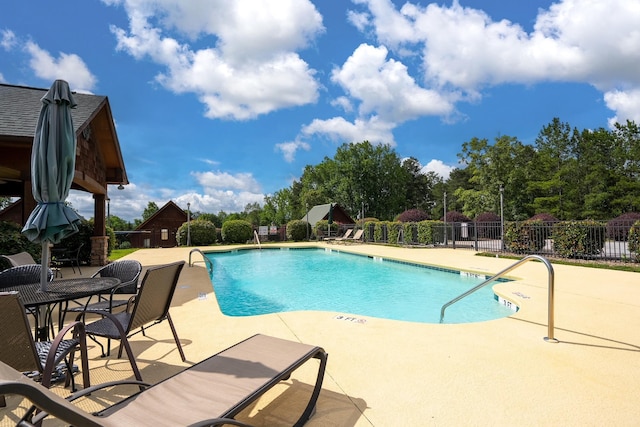 view of swimming pool with a patio area