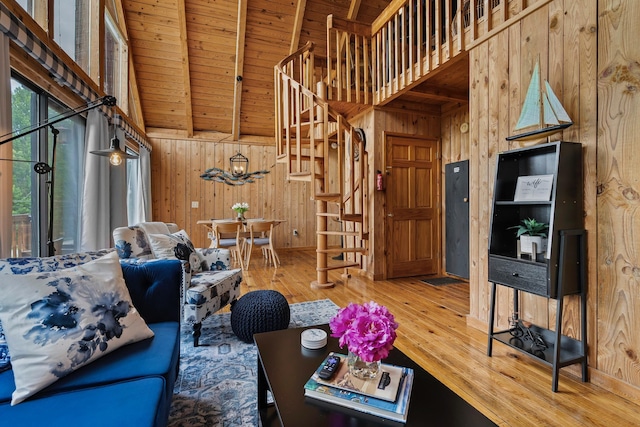 unfurnished living room with beamed ceiling, wooden ceiling, high vaulted ceiling, and wood walls