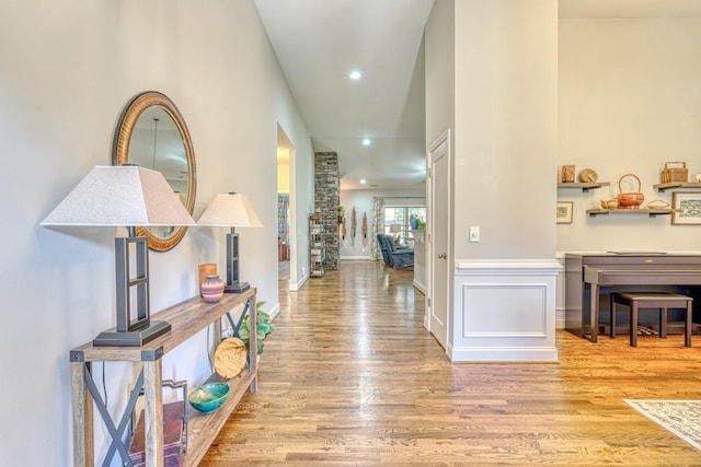 corridor with hardwood / wood-style flooring