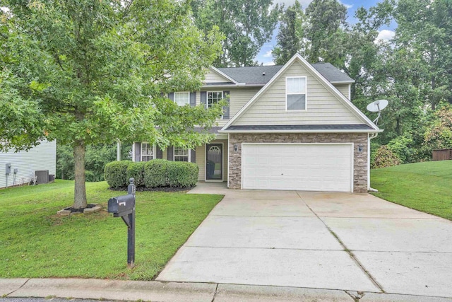 view of front of home featuring cooling unit, a garage, and a front lawn