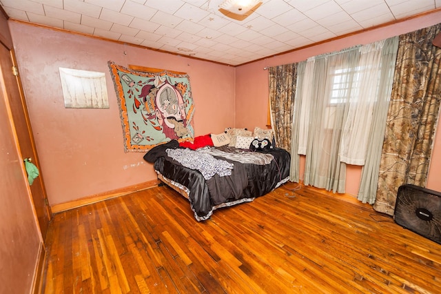 bedroom featuring hardwood / wood-style flooring and crown molding