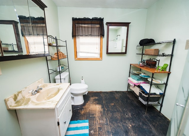 bathroom with vanity, hardwood / wood-style floors, a wealth of natural light, and toilet