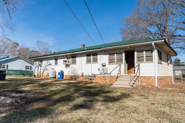 rear view of house with a yard