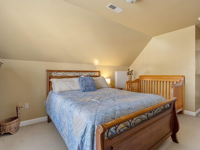 bedroom featuring lofted ceiling and light carpet