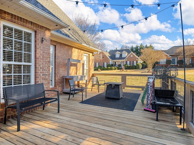 wooden terrace featuring an outdoor fire pit