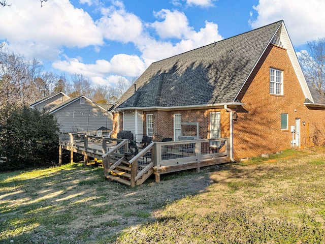 back of house with a wooden deck and a lawn