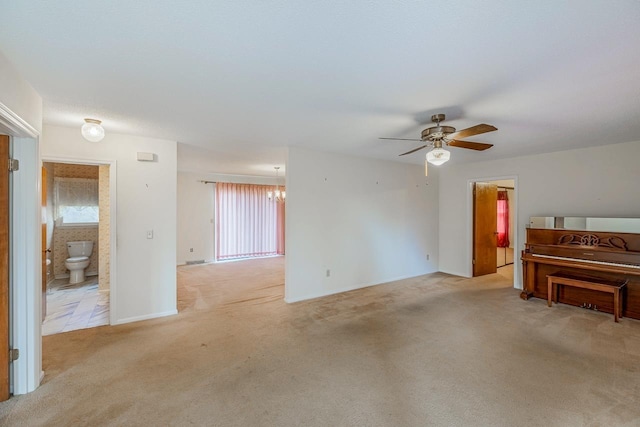 living room featuring ceiling fan with notable chandelier and light carpet