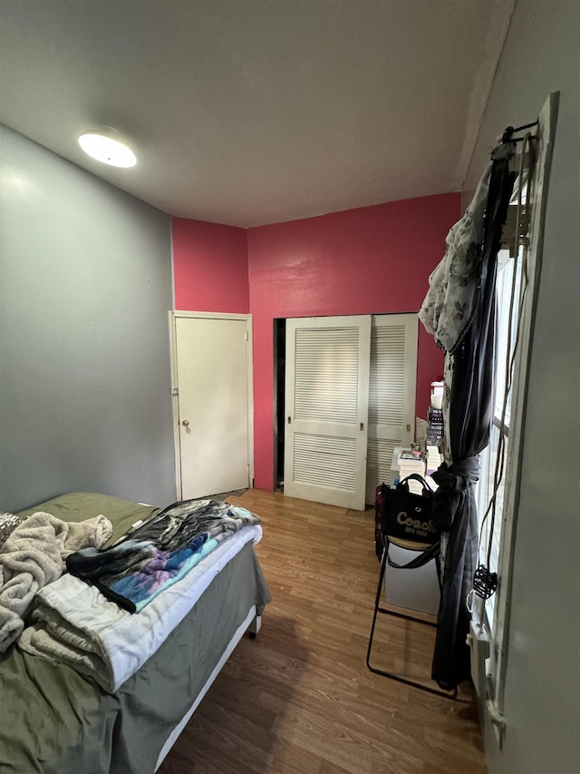 bedroom with hardwood / wood-style floors