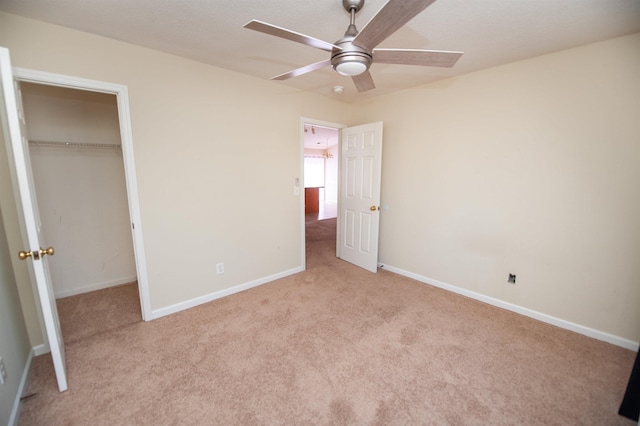 unfurnished bedroom with ceiling fan, a closet, and light colored carpet