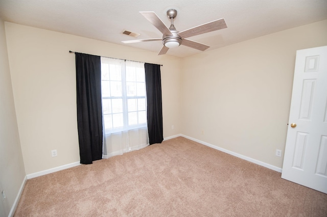 empty room featuring light carpet and ceiling fan