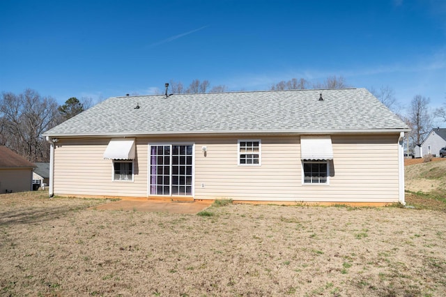 rear view of property featuring a patio and a lawn