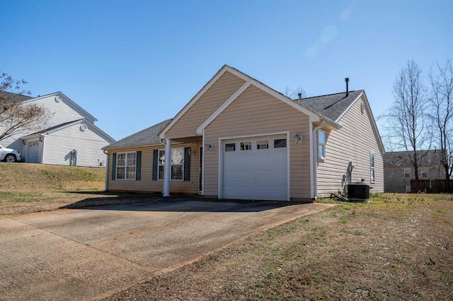 view of front of property with central AC and a garage