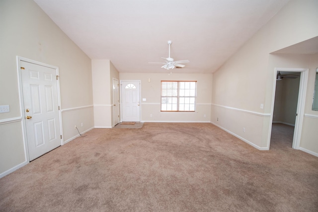 unfurnished living room featuring light carpet, vaulted ceiling, and ceiling fan