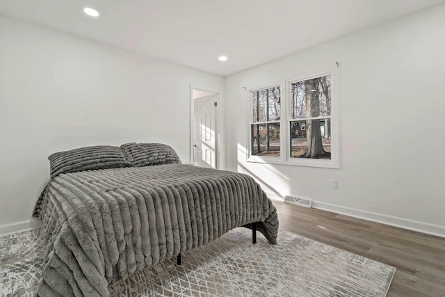 bedroom with hardwood / wood-style floors