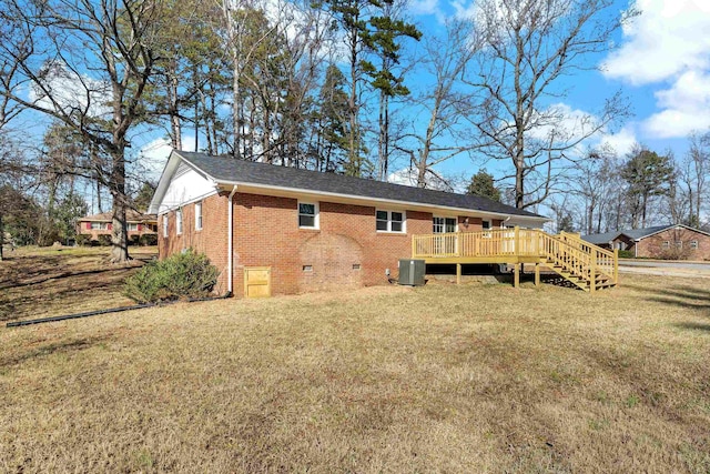 back of house with central AC unit, a yard, and a wooden deck